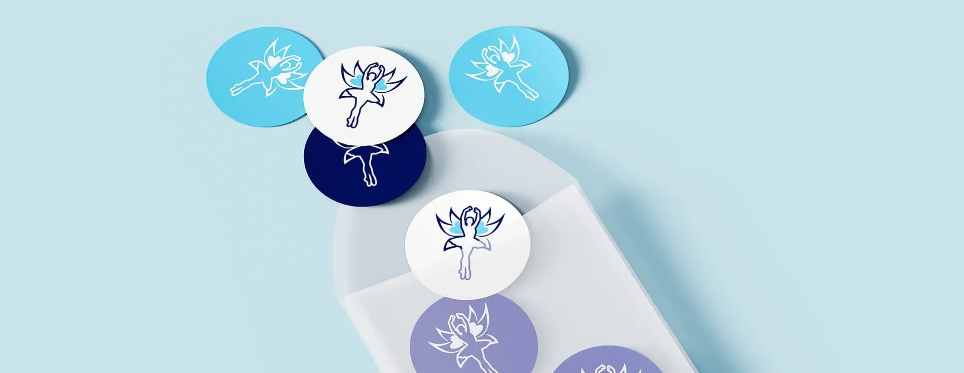 A collection of circular stickers featuring a stylized bird design, arranged on a light blue background. The stickers are in various shades of blue and white, with some overlapping each other. Butterfly Fly Away Photography
